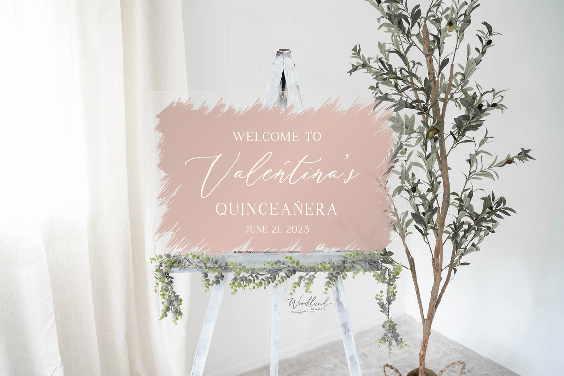 May include: A pink welcome sign with a brushstroke effect, announcing "Welcome to Valentina's Quinceañera June 21, 2025".