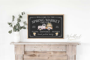Spring Market Framed Sign. Sign Says Welcome to the Spring Market, open daily, you pick. Tulips, daffodils, peonies, hand picked daily. Has picture of a pink vintage truck filled with pink and yellow flowers.